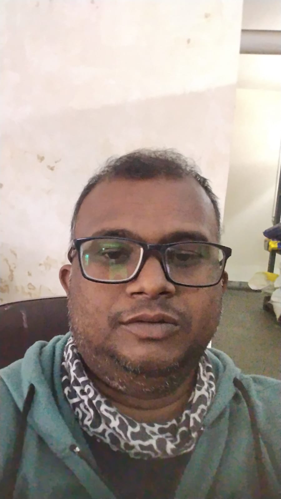 Professional woman with long brown hair smiling warmly in casual blue sweater